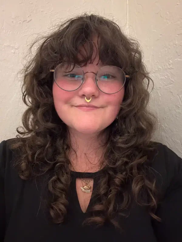woman with curly hair facial specialist