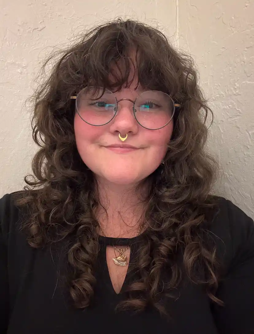 woman with curly hair facial specialist