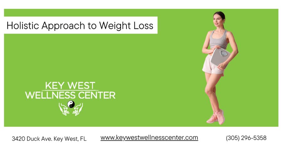 woman standing with a scale in hands wearing sports clothes